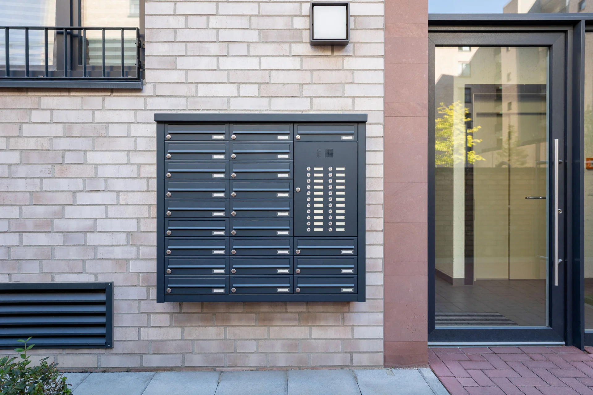 Knobloch mailbox system mounted on a brick wall